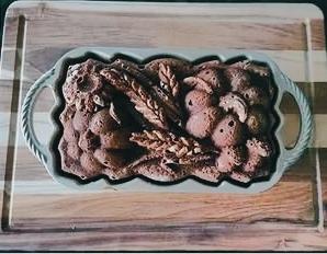 A beautifully pattern-molded heirloom fruit cake loaf in its pan